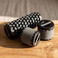 Close-up of a compact telescopic foam roller with metallic joints on a wooden surface, highlighting its portability and foam texture.