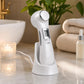 Full-body shot of 6-in-1 Beauty Device on a clean, minimalist bathroom counter, emphasizing its portability and rechargeable feature in a calm environment.