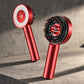 Grey 3-in-1 scalp massager resting on a brushed concrete surface, highlighting its metallic finish.
