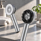 Detailed view of a 3-in-1 scalp massager featuring a metallic finish displayed on a polished concrete shelf.