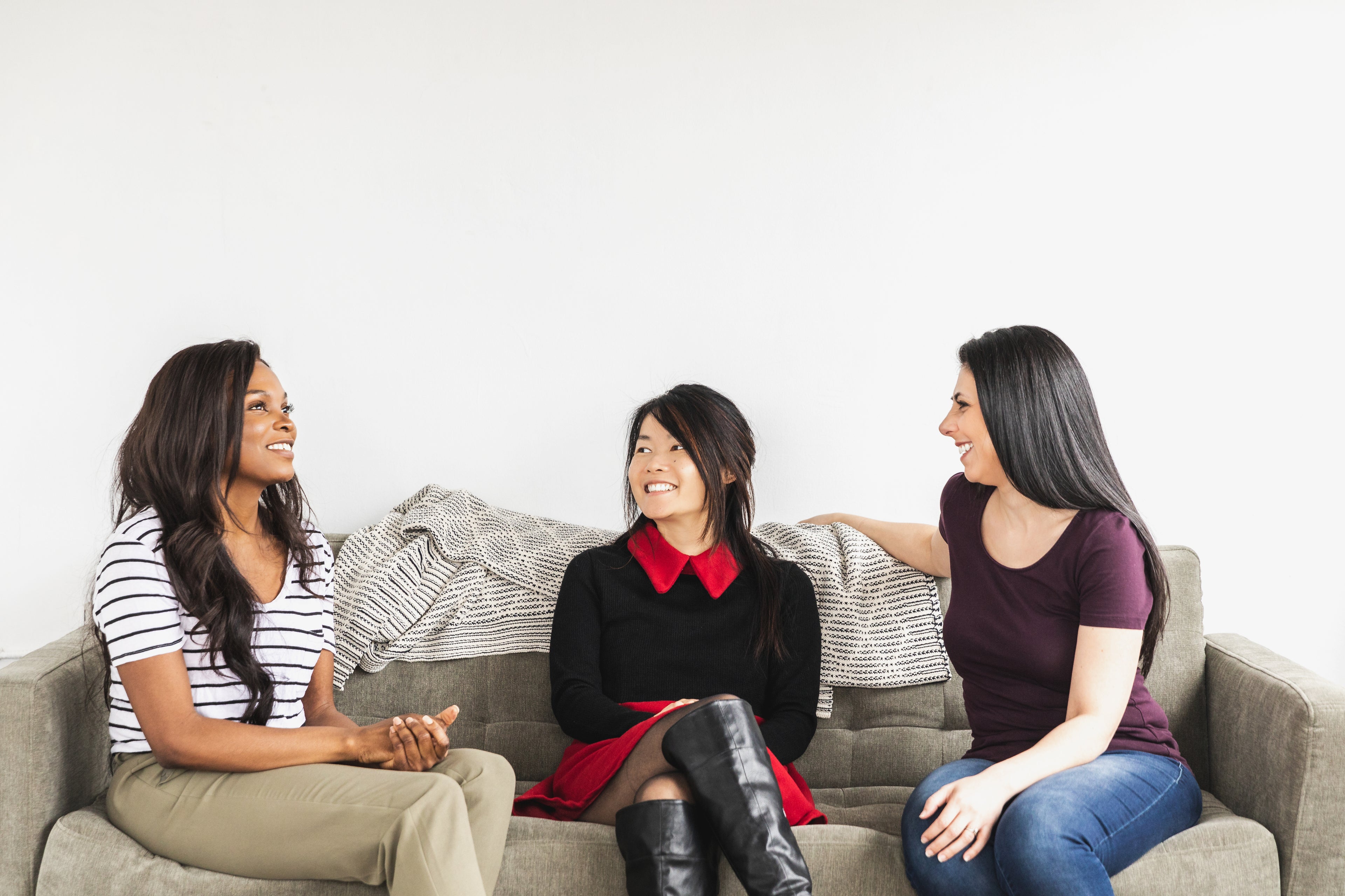 Three Models Share a Smile on a Grey Sofa | Kiicity.com